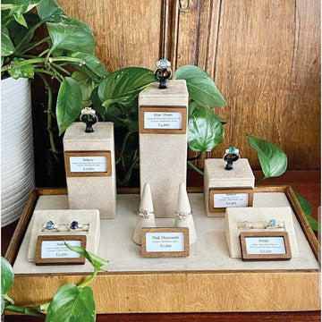 Natural wood mini price holders in a jewelry store display case