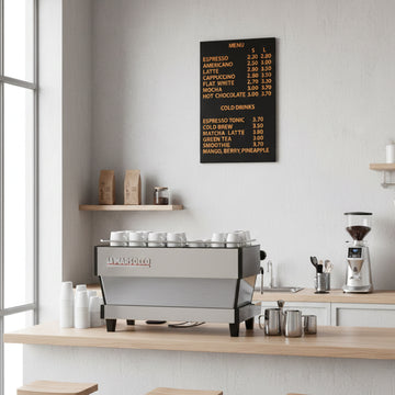 Multiple magnetic menu boards arranged behind a coffee counter in a contemporary café environment.