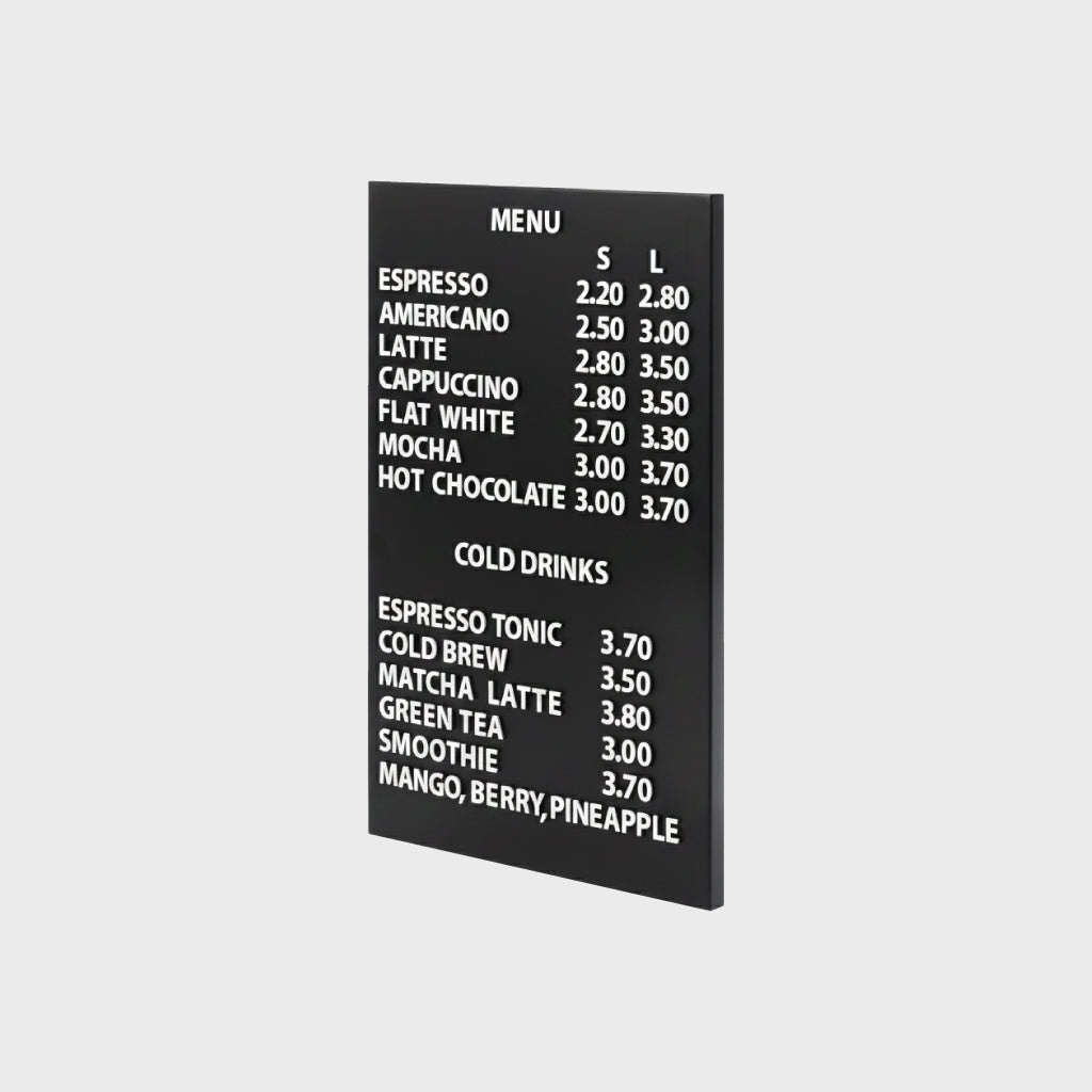 Magnetic black menu board with white wooden letters mounted on a wall.