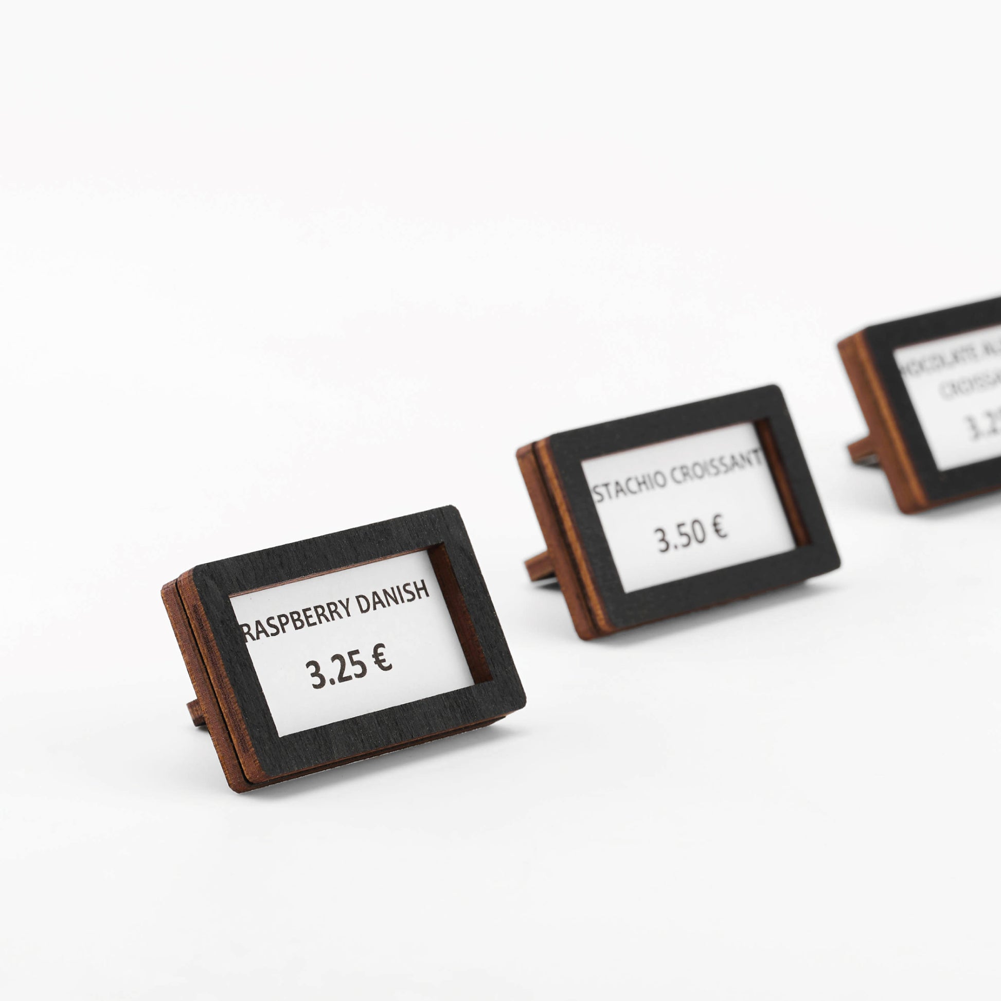 Retail coffee shop setup with wooden mini price holders displaying prices 