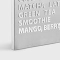 A-frame stainless steel menu board displaying a drinks menu