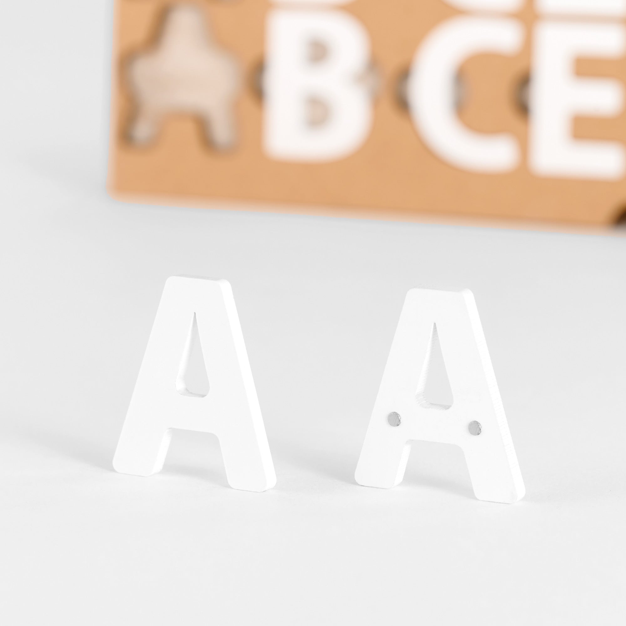 Close-up view of white acrylic magnetic letters used for menu boards.