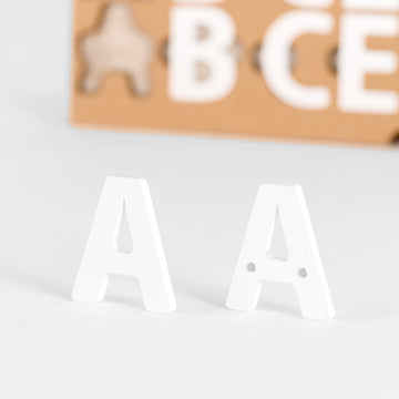Close-up view of white acrylic magnetic letters used for menu boards.
